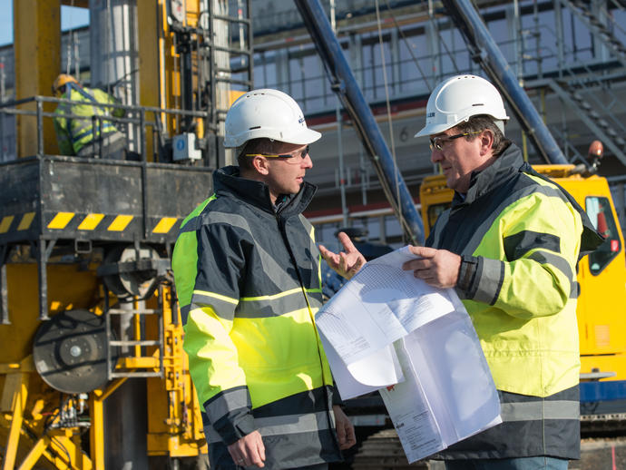 Employees on site discussing project